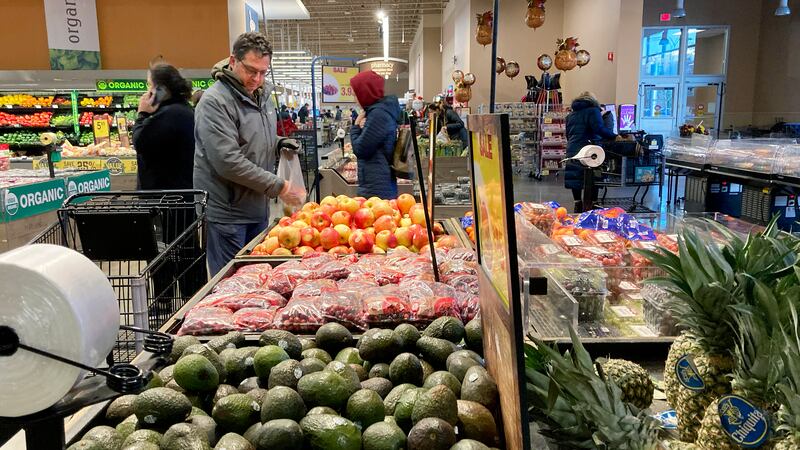 Shoppers pick out items at a grocery store in Glenview, Ill., Saturday, Nov. 19, 2022.