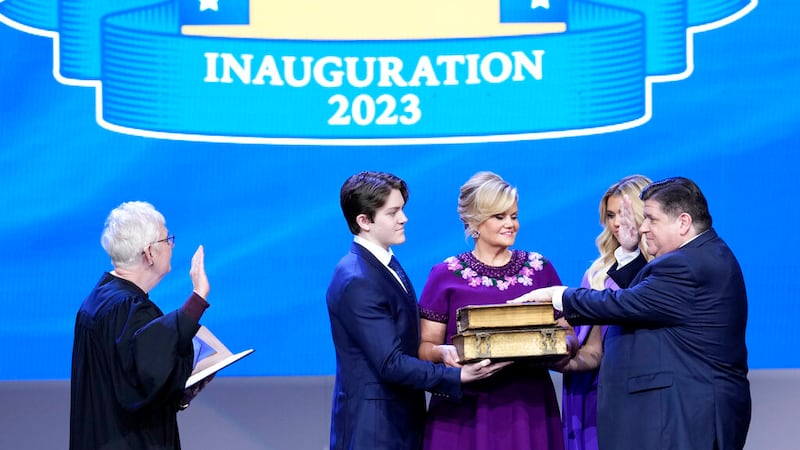 Illinois Gov. J.B. Pritzker, right, takes the office from Mary Jane Theis, Illinois Supreme...